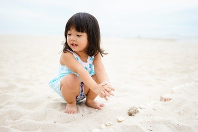little asian girl playing on the beach.vacation and relax concept.
