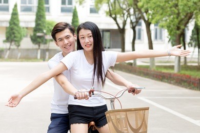 couples ride bikes in the park