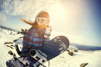 girl snowboarder enjoys the ski resort. sheregesh. russia.