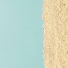 creative minimal beach concept. summer vacation layout with sand on blue background. flat lay.