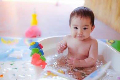 happy baby taking a bath