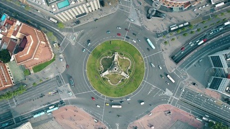 aerial shot of plaza de espana in barcelona, spain. roundabout city traffic, top view