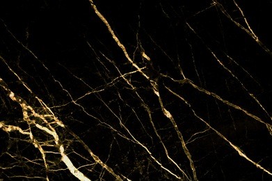 gold marble texture with lots of bold contrasting veining (natural pattern for backdrop or background, can also be used for create surface effect to architectural slab, ceramic floor and wall tiles)