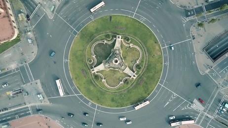 aerial rising shot of plaza de espana in barcelona, spain. roundabout city traffic, top view