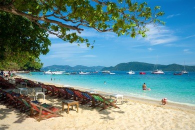 banana beach on coral (ko he) island on a sunny day, phuket, thailand 