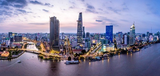 aerial view of bitexco financial tower  building, century link, train tracks, buildings, roads, and saigon river in ho chi minh city.high quality stock image panorama