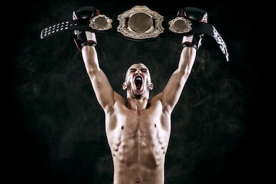 boxer with champion belt celebrating flawless victory isolated on black background with copy space..