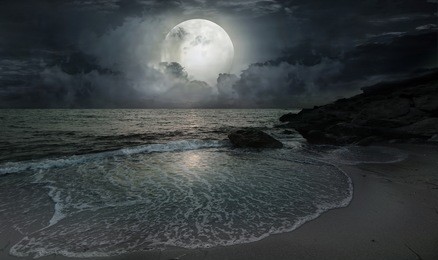 a quiet evening by the ocean with moonlight and a big moon
