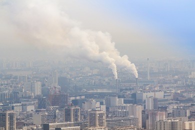 air pollution by smoke coming out of two factory chimneys, paris, france