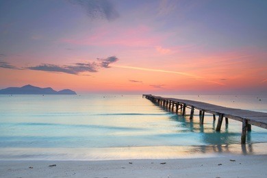 amazing sunrise at wooden pier on the beach                                       