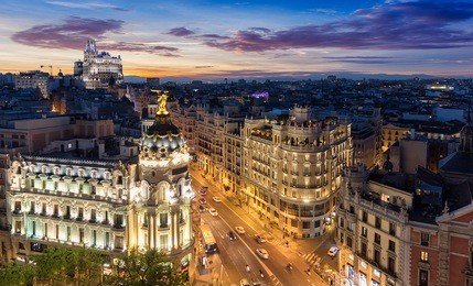 the skyline of madrid, spain, by night: where gran via and alcala street meet