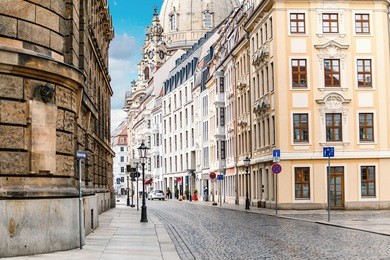 a narrow street in the historic center of dresden in the morning without pedestrians and cars