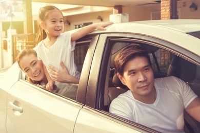 happy asian family traveling by car.