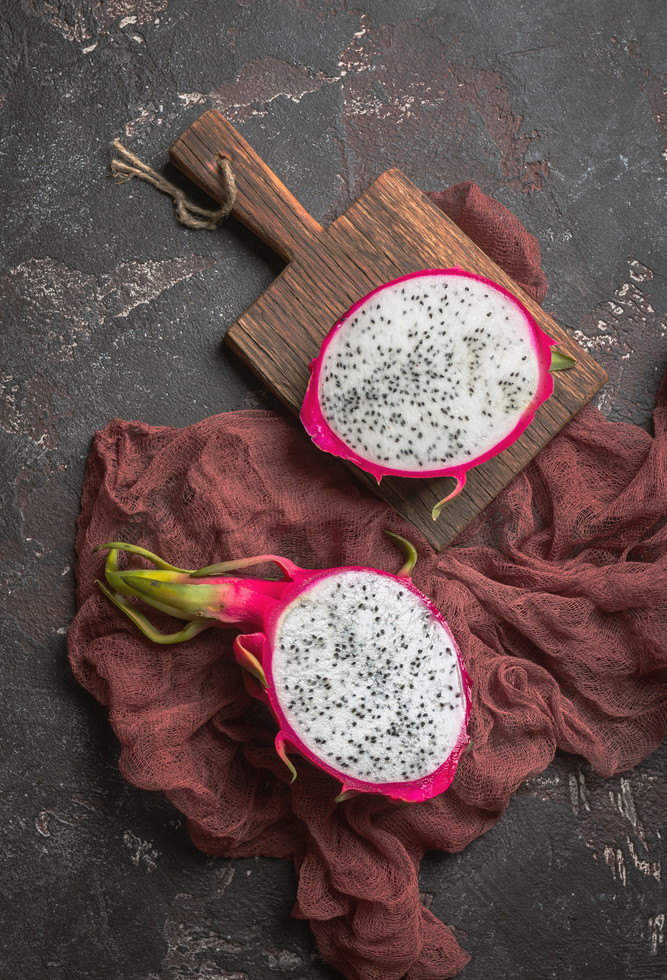 asian dragon fruit on black background, top view with copy space