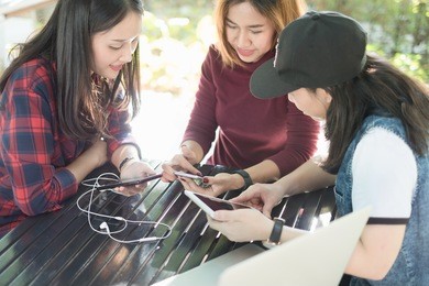 three asian woman are chatting at coffee shop. feeling enjoy and happy.