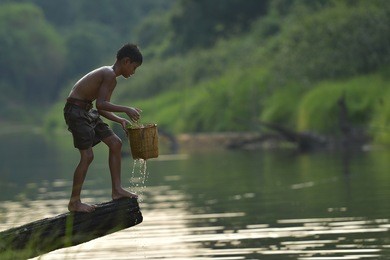boy playing river water