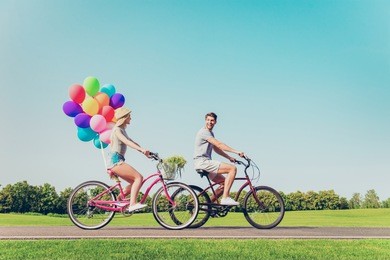 happy family having summer weekend and riding bicycles