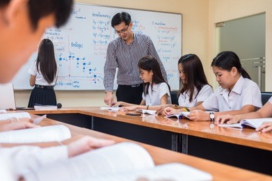 asian teacher giving lesson to group of college students in the classroom, university education concept