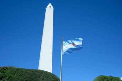 argentina flag and the obelisk of buenos aires