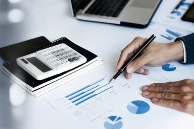 business man working in office with calculator and laptop