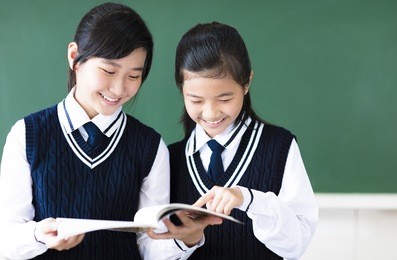 smiling  teenager student girls in  classroom