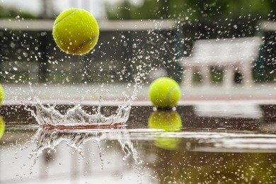 tennis court. hard court in raining weather. yellow tennis ball bouncing