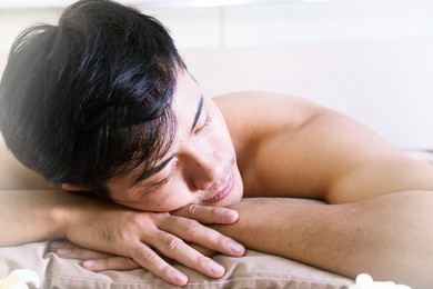 man is relaxing with massaging in day spa