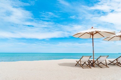 beach chair with umbrella with blue sky on tropical beach.