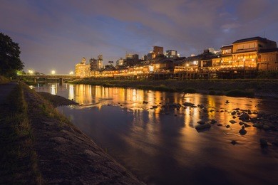 old house and restaurant in kamo river or kamogawa river at sunset, gion, kyoto, japan