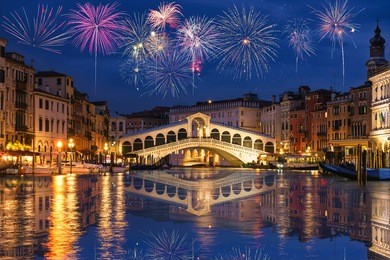 rialto bridge and garnd canal with fireworks in venice, italy