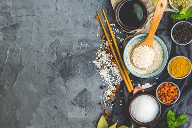 rice and food ingredients over dark rustic background. vegetarian concept. asian or indian food 