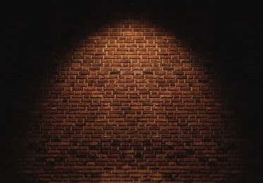 bricks wall with light spot on center backgrounds