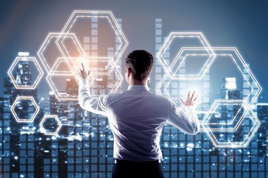 back view of young businessman managing digital cells on night city background. fintech concept. 3d rendering