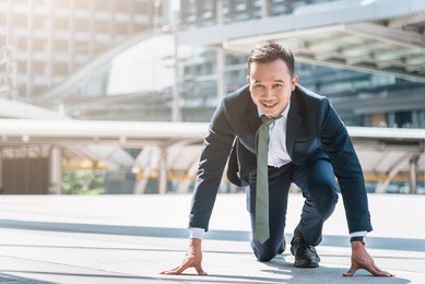 happy confident asian businessman ready to start his career or business with city in background. business start concept.