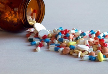 capsules and pads come out of a dark bottle