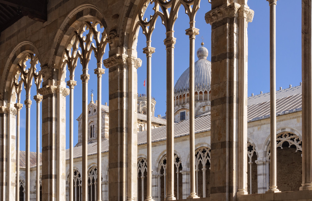 the roof and dome of the duomo as seen through the traceried windows of the camposanto - pisa, tuscany, italy
