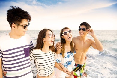 happy young group walking on the beach enjoy summer vacation
