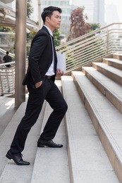confident businessman stepping up to success