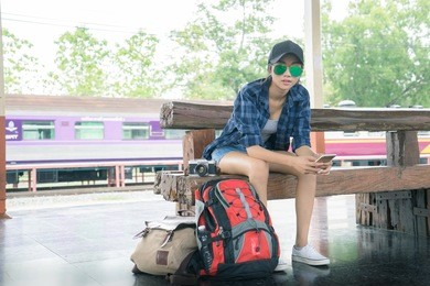 beautiful young asian girl traveling alone at train station