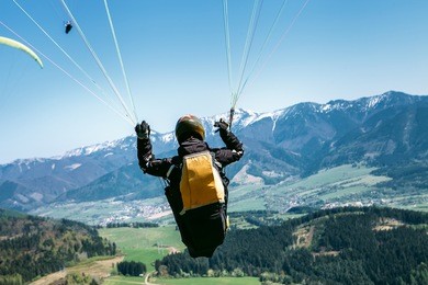paraglider is on the paraplane strops - soaring flight moment