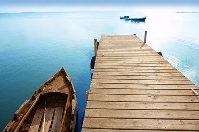 albufera lake wetlands pier with boat in valencia spain