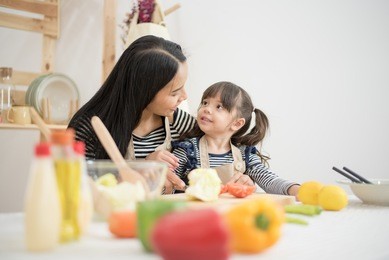 loving family are preparing bakery together. mother and daughter are cooking and having fun in the kitchen.