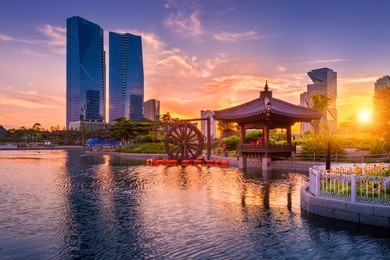 traditional and modern architecture of seoul city in sunset, central park in songdo international business district, incheon south korea.