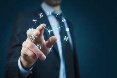 businessman hand holding clock in the screen