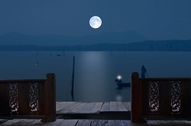 pathway and balcony beside the lake in full moon night