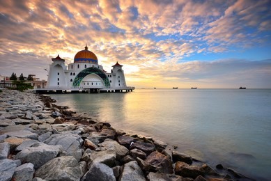 malacca straits mosque ( masjid selat melaka) with beautiful sunset background. it is a mosque located on the man-made malacca island near malacca town, malaysia