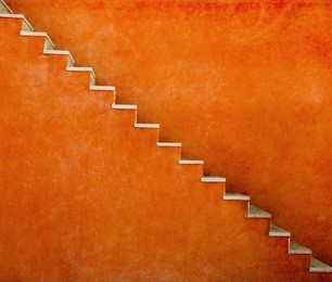 orange wall with stairs texture background, minimalistic style for base image for posters, banners or covers, trivial design and simplicity is a trendy key for graphic arts, acid psychedelic color