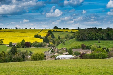 cotswolds village with stone home in green valley