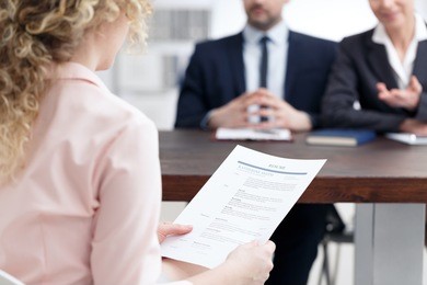 young woman holding her resume during job interview