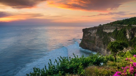 wonderful twilight sunset seascape of uluwatu temple cliff with pavilion and blue sea in bali, indonesia. the sky is burst.